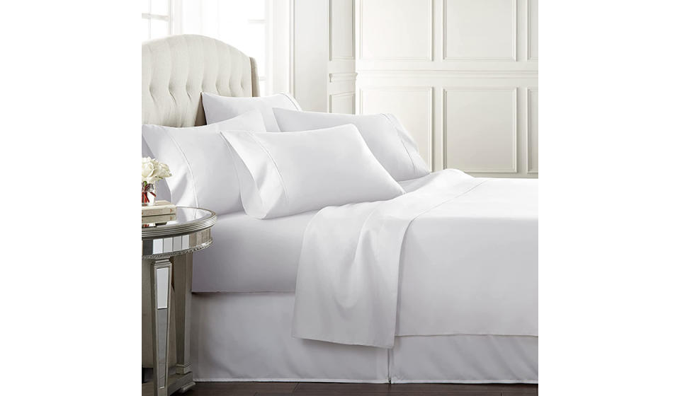 A photo of a bed with white sheets. 