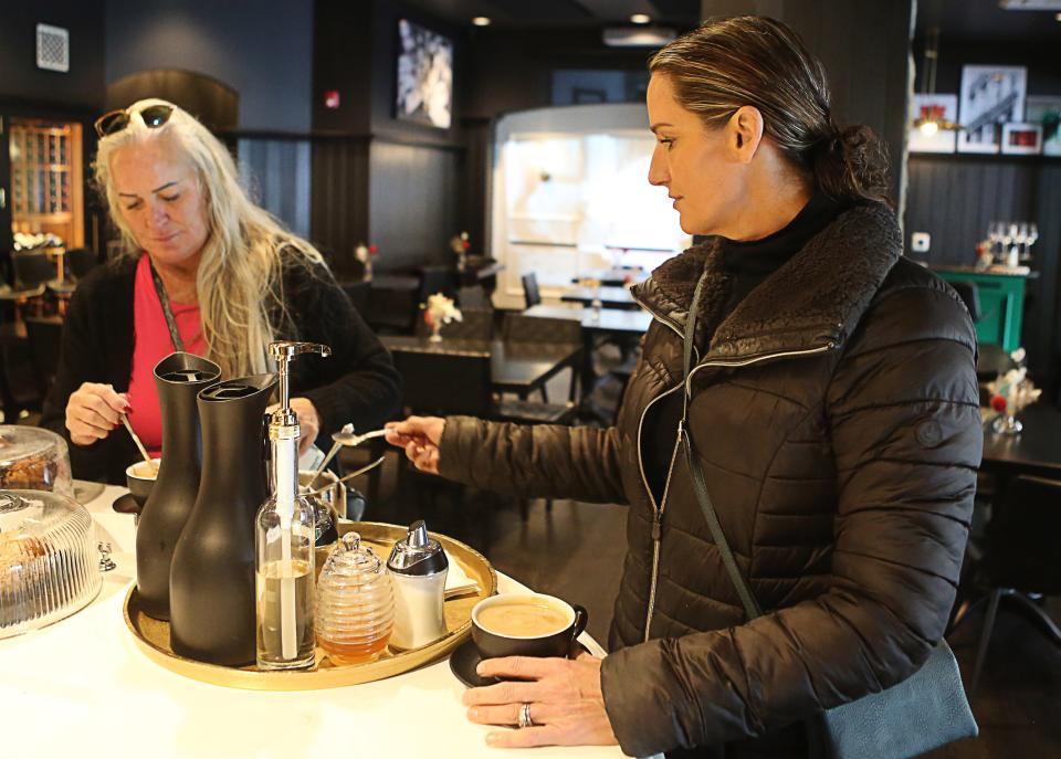 Sarah Gillespie, of West Chester, Pa. (right) and Joy Greggo, of Wilmington (left), fix their morning cup of coffee at Bar Reverie in Greenville on Thursday November 9, 2023.