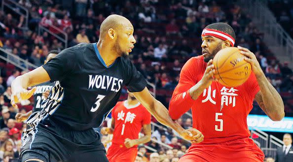 Josh Smith #5 of the Houston Rockets drives with the basketball against Adreian Payne #3 of the Minnesota Timberwolves  during their game at the Toyota Center on February 23, 2015 in Houston, Texas.  (Photo by Scott Halleran/Getty Images)