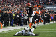 Cincinnati Bengals' Ja'Marr Chase (1) makes a catch against Las Vegas Raiders' Desmond Trufant (10) during the first half of an NFL wild-card playoff football game, Saturday, Jan. 15, 2022, in Cincinnati. (AP Photo/Jeff Dean)