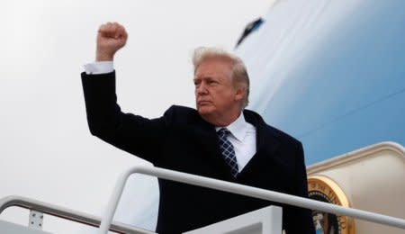 U.S. President Donald Trump pumps his fist as he boards Air Force One upon departure from Joint Base Andrews in Maryland, U.S., January 12, 2018.  REUTERS/Kevin Lamarque