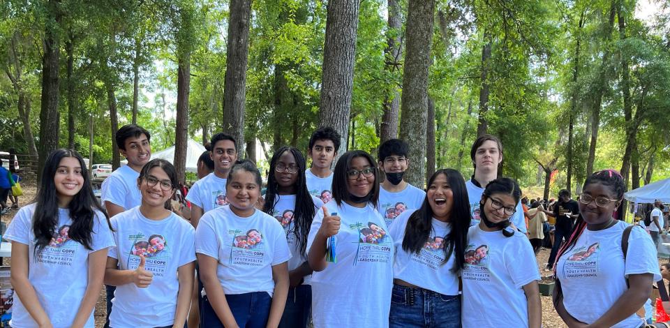 The 13 members of the 2022 Cohort of Youth Health Leadership enjoy their achievements at the Tallahassee Earth Day Festival.