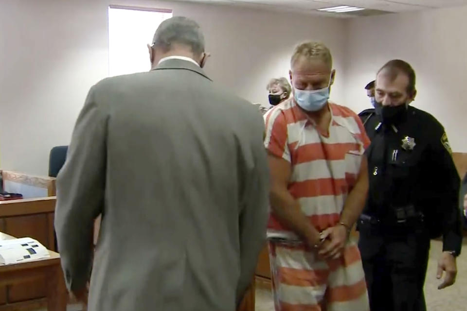 In this still image from video, Barry Morphew, center, appears in court in Salida, Colo., Thursday, May 6, 2021. Morphew was arrested on Wednesday, May 5, in connection with the disappearance of his wife, Suzanne Morphew, who was last seen a year ago on Mother's Day, May 10, 2020. (KUSA via AP, Pool)