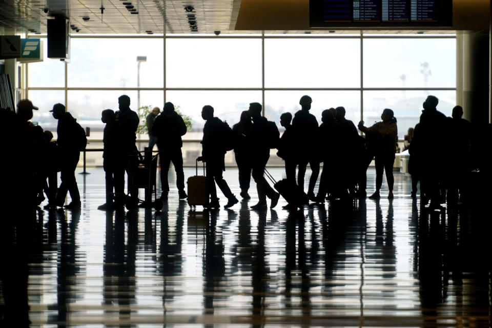 FILE - In this March 17, 2021 file photo, travelers walk through the Salt Lake City International Airport in Salt Lake City. On Friday, June 4, 2021, The Associated Press reported on stories circulating online incorrectly asserting that airlines recently met to discuss the risks and liability of carrying passengers vaccinated against COVID-19. (AP Photo/Rick Bowmer, File)