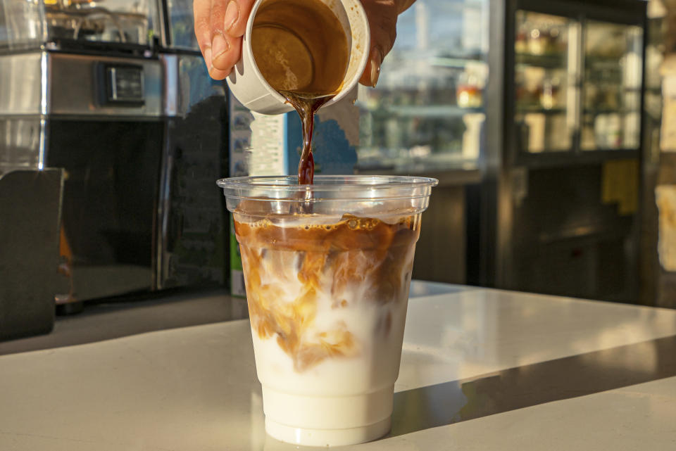 barista making an iced latte