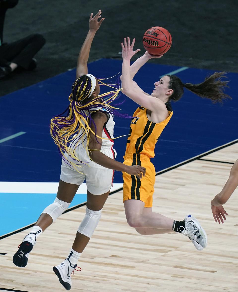 FILE - Iowa guard Caitlin Clark (22) drives to the basket against UConn forward Aaliyah Edwards (3) during the first half of a college basketball game in the Sweet Sixteen round of the women's NCAA tournament at the Alamodome in San Antonio, Saturday, March 27, 2021. Caitlin Clark has been a must-see attraction on the road this year with some tickets going for thousands of dollars on the secondary market. (AP Photo/Eric Gay, File)