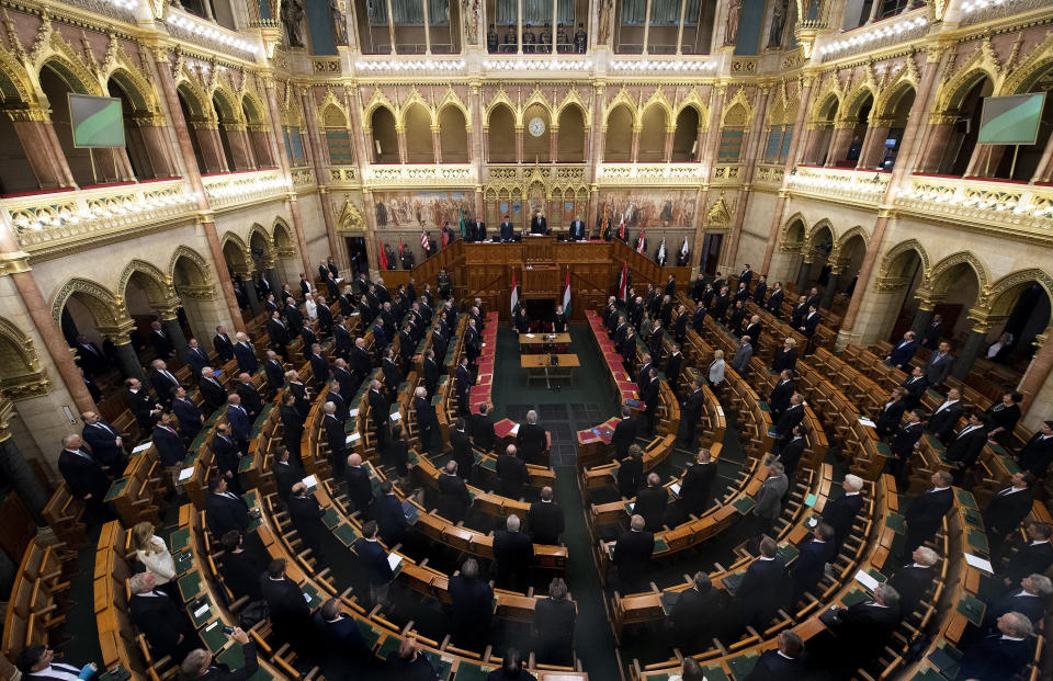 Lawmakers attend the commemorative parliamentary session marking the centenary of the Trianon Peace Treaty in Budapest, Hungary, Thursday, June 4, 2020. Hungary is commemorating the 100th anniversary of a post-World War I peace treaty which led to the loss of about two-thirds of its territory and left some 3.3 million Hungarians outside the country's new borders. (Tibor Illyes/MTI via AP)