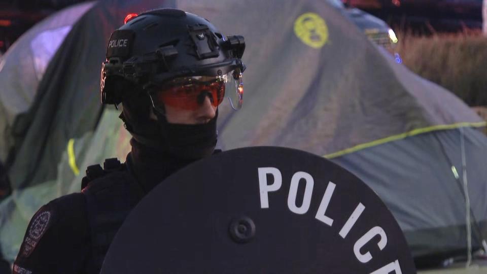 Calgary police are on the scene at a pro-Palestinian encampment at the University of Calgary campus after protesters refused to leave. (Jo Horwood/CBC - image credit)