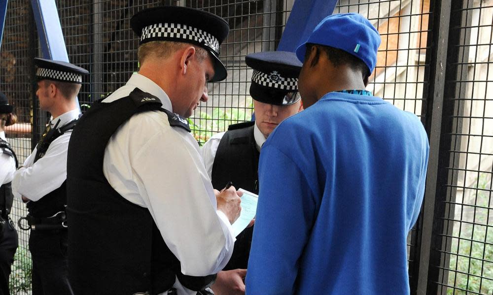 Metropolitan police conducting a stop and search.