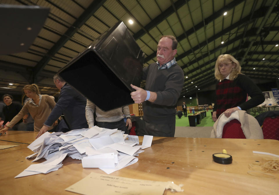 Ballot boxes are opened at the start of the Irish General Election count in Dublin, Sunday Feb. 9, 2020. Irish voters are choosing their next prime minister in an election where frustration with economic austerity and a housing crisis seem to have fuelled political uncertainty. (Niall Carson/PA via AP)