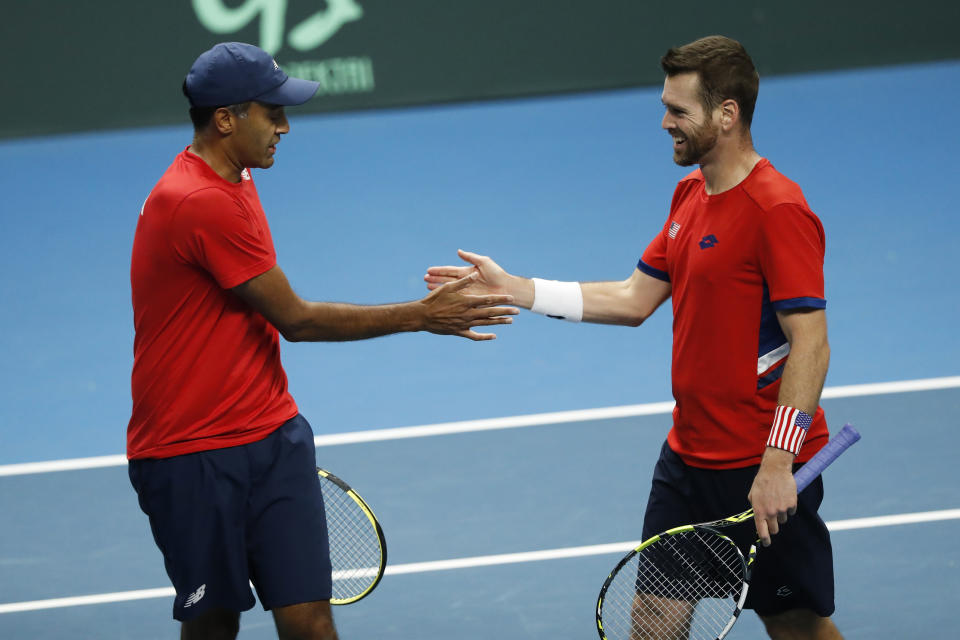 Rajeev Ram, left, and Austin Krajicek of the USA react during their match against Illya Beloborodko and Oleksii Krutykh of Ukraine during a Davis Cup qualifier doubles tennis match between Ukraine and USA, in Vilnius, Lithuania, Friday, Feb. 2, 2024. (AP Photo/Mindaugas Kulbis)