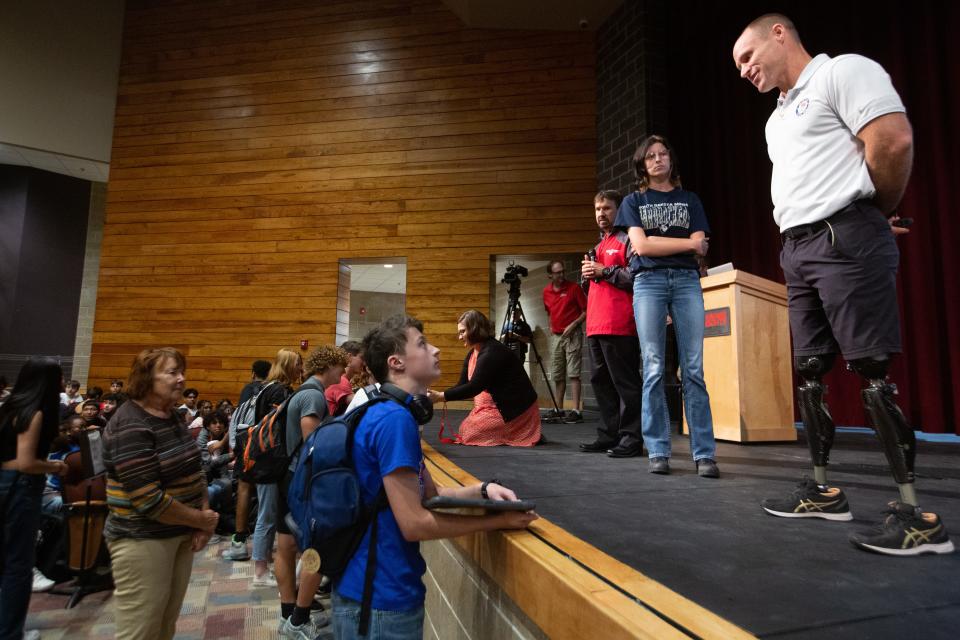 Dan Cnossen takes time to talk one-on-one with high school juniors following his presentation at Shawnee Heights High School on Wednesday. Cnossen discussed his life as a Navy Seals platoon leader and a three-time U.S. Paralympic skier.