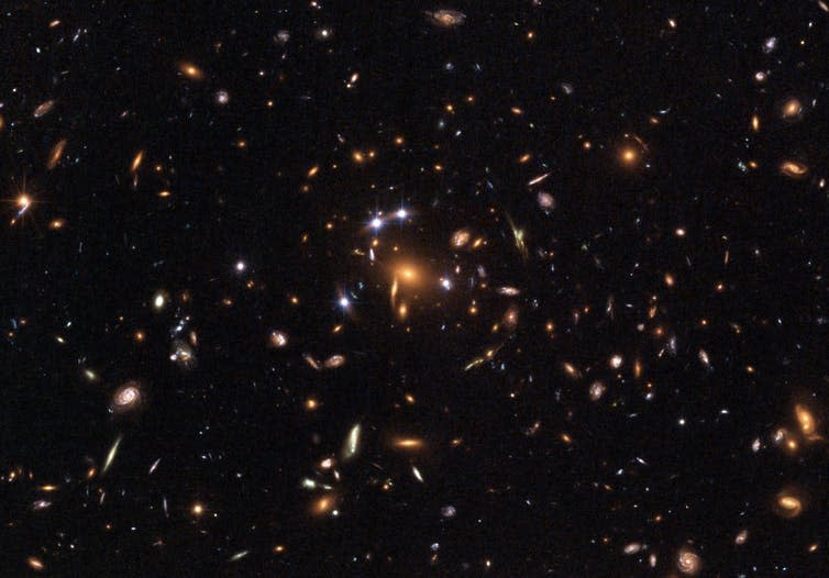 <span class="caption">Galaxy cluster SDSS – what’s pushing it apart at an accelerated rate?</span> <span class="attribution"><span class="source">ESA, NASA, K. Sharon (Tel Aviv University) and E. Ofek (Caltech).</span></span>