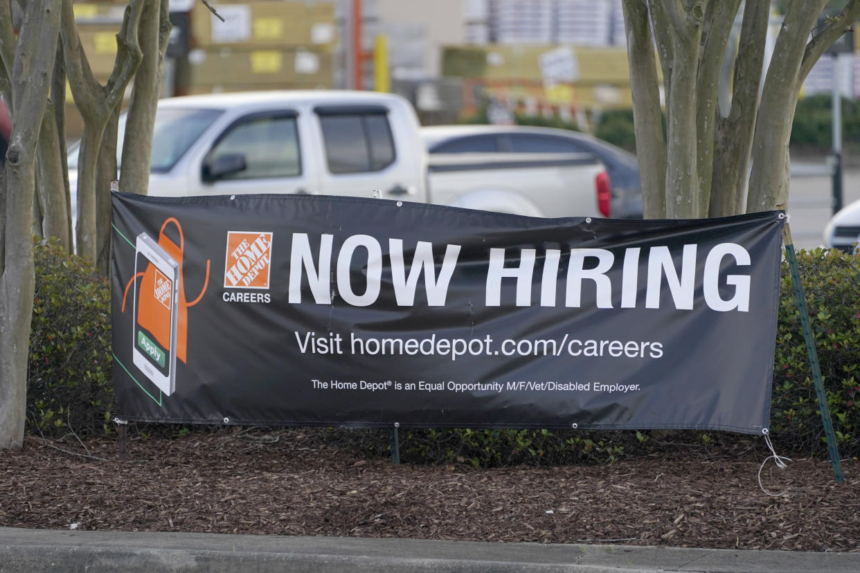 A roadside banner beckons potential employees outside a Home Depot store in Hattiesburg, Miss., March 27, 2021. The number of Americans applying for unemployment benefits rose by 61,000 last week to 719,000, signaling that many employers are still cutting jobs even as more businesses reopen, vaccines are increasingly administered and federal aid spreads through the economy.   (AP Photo/Rogelio V. Solis)