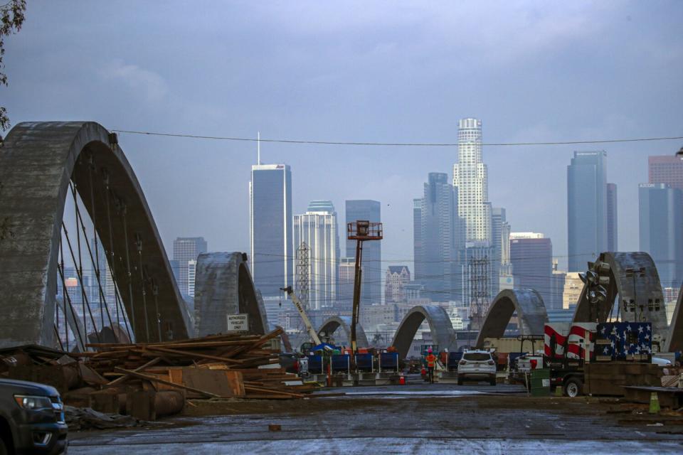 A view of the 6th Street Bridge from the top with the downtown Los Angeles skyline in the distance.