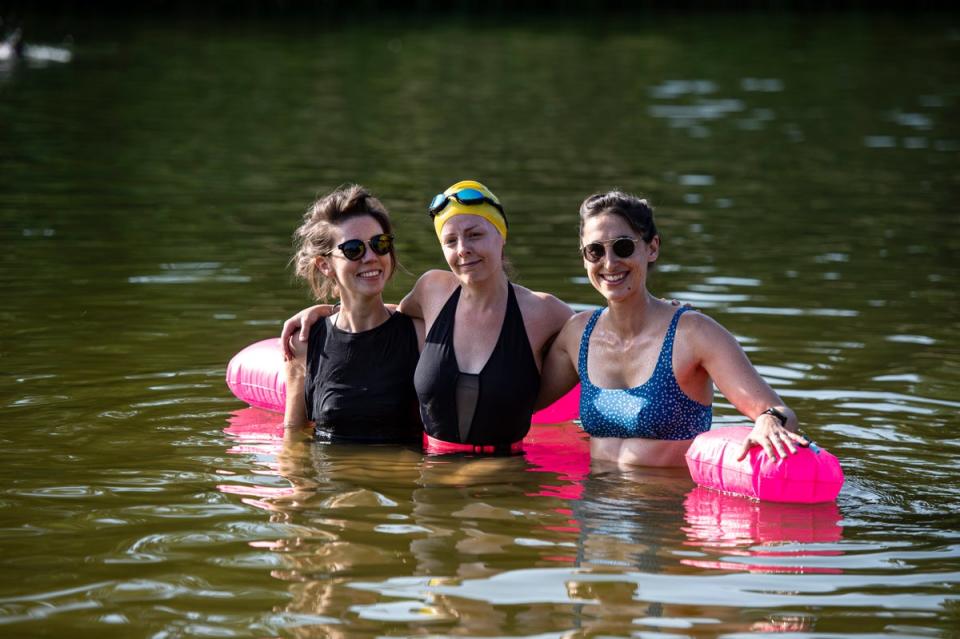 Three swimmers pictured keeping cool with a swim at Beckenham Place Park, Kent (Daniel Hambury/Stella Pictures Ltd)