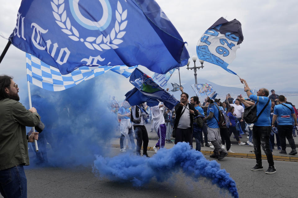 Napoli fans celebrates on the street after their team scored the first goal during the Serie A soccer match between Napoli and Salernitana at the Diego Armando Maradona stadium, in Naples, Italy, Sunday, April 30, 2023. (AP Photo/Gregorio Borgia)