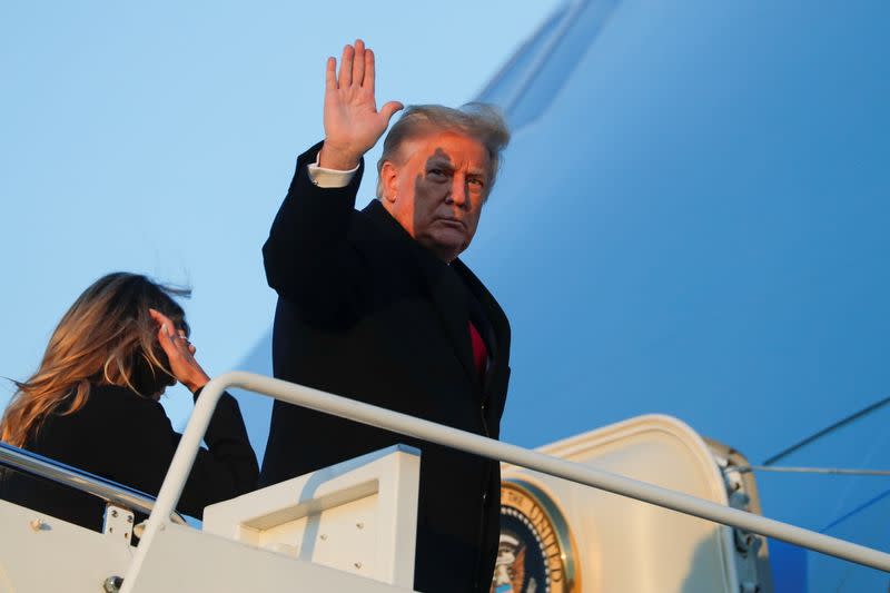 U.S. President Donald Trump boards Air Force One beside first lady Melania Trump at Joint Base Andrews in Maryland