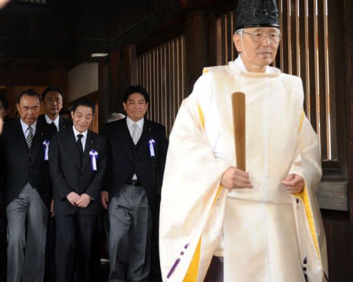 Japanese Land and Transport Ministedr Yuichiro Hata (3rd L) and lawmakers follow a Shinto priest during a visit to the controversial Yasukuni shrine to honour the dead on the 67th anniversary of Japan's surrender in World War II, in Tokyo, on August 15. The visit is likely to provoke outrage in China and South Korea
