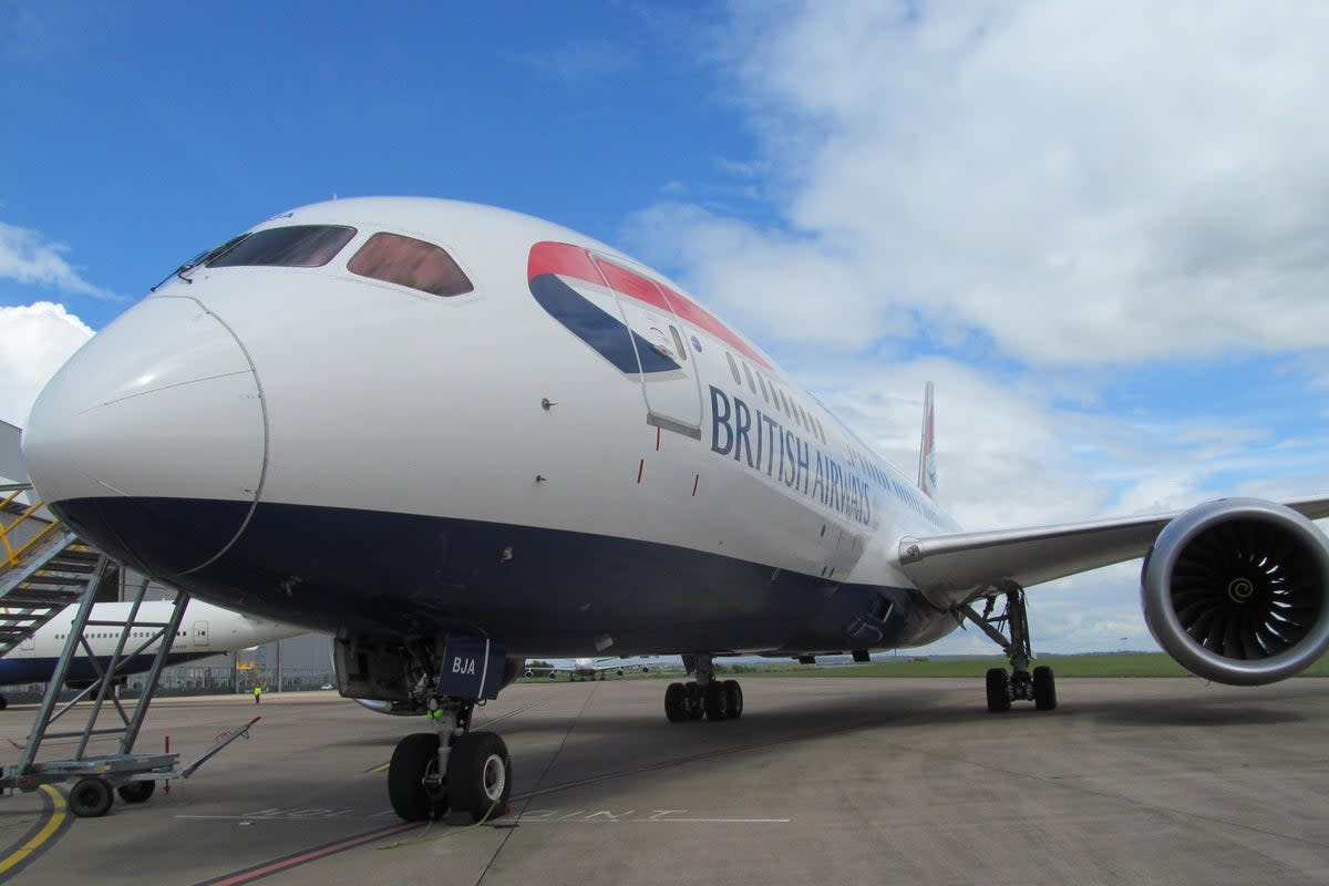A vehicle with mobile stairs burst into flames next to a British Airways plane