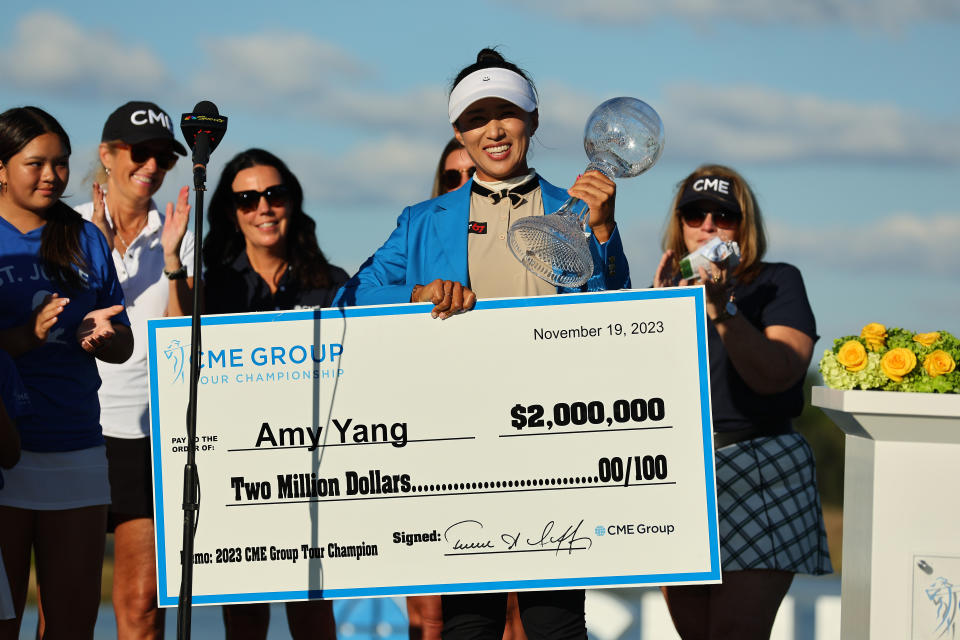 Amy Yang celebrates with the CME Globe trophy and her check during the trophy ceremony after winning the CME Group Tour Championship at Tiburon Golf Club on November 19, 2023 in Naples, Florida. (Photo by Michael Reaves/Getty Images)