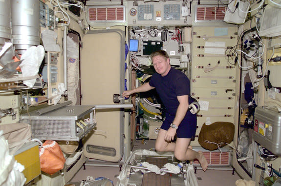 The first commander of the International Space Station, Bill Shepherd, floats inside the Zvezda service module in 2000.