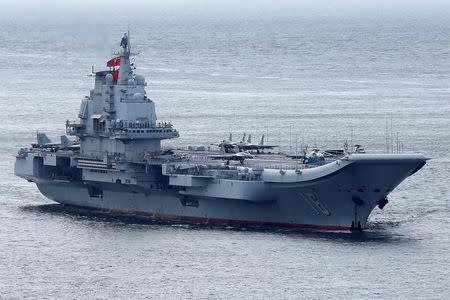 Members of the People's Liberation Army navy are seen on board China's aircraft carrier Liaoning as it sails into Hong Kong, China July 7, 2017. REUTERS/Bobby Yip