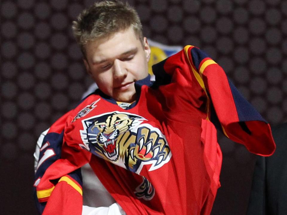 Jun 30, 2013; Newark, NJ, USA; Aleksander Barkov puts on a jersey as he is introduced as the number two overall pick to the Florida Panthers during the 2013 NHL Draft at the Prudential Center.
