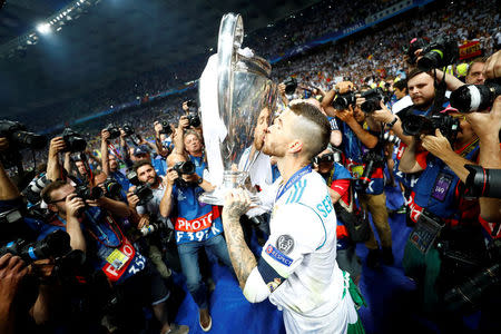 Soccer Football - Champions League Final - Real Madrid v Liverpool - NSC Olympic Stadium, Kiev, Ukraine - May 26, 2018 Real Madrid's Sergio Ramos kisses the trophy as he celebrates winning the Champions League REUTERS/Kai Pfaffenbach