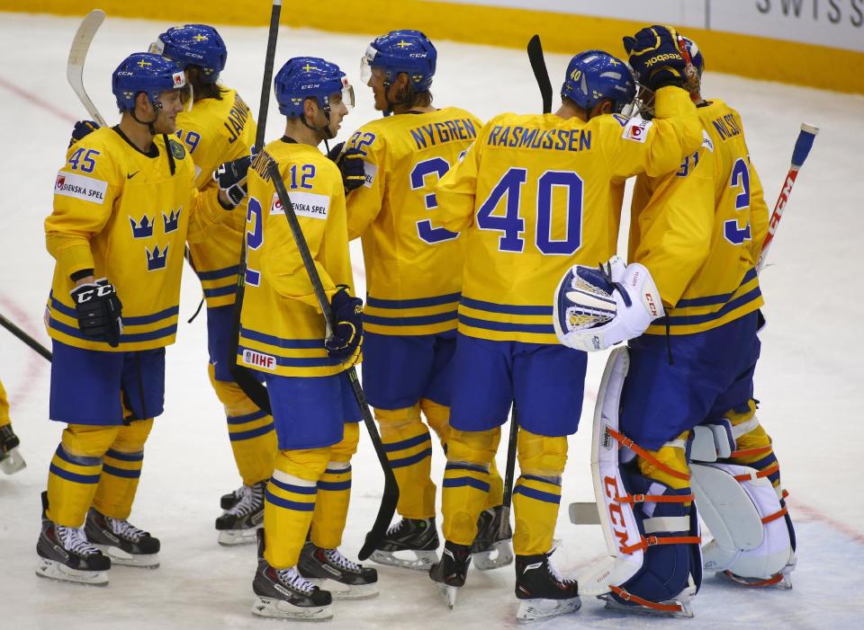 Sweden's players their victory during the Group A preliminary round match against Norway at the Ice Hockey World Championship in Minsk, Belarus, Tuesday, May 13, 2014. (AP Photo/Sergei Grits)