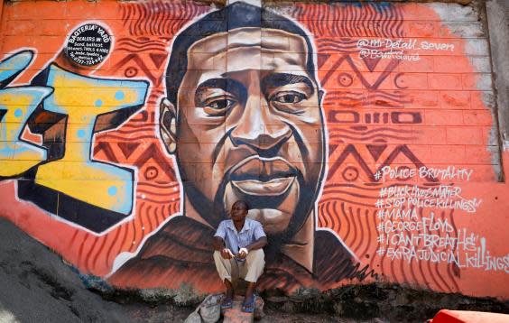 A mural of George Floyd who died by asphyxiation after a white police officer knelt on his neck for over eight minutes (Reuters)