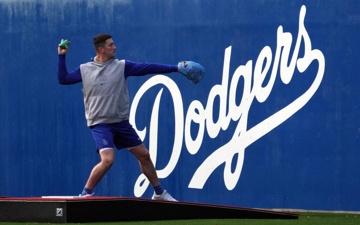 Dodgers pitcher Bobby Miller stretches during a workout at Camelback Ranch.