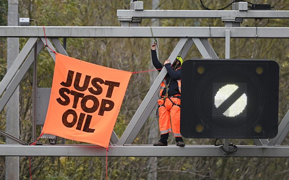 A Just Stop Oil activist climbed a gantry above the M25 last November, causing severe delays - GETTY IMAGES