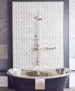 <p> Shower tiling doesn&#x2019;t have to be confined to a cubicle. If you&#x2019;re looking for a practical backsplash to a standalone bathtub and shower head, use tiles to turn an awkward wall space into a work of art.&#xA0; </p> <p> In the bathroom wall idea shown above, just part of the wall has been filled with patterned tiles to create a deliberate feature, framed like a picture with wall paint. Tiling just a small &#x2014; but carefully chosen &#x2014; area is great for using more expensive tiles to make an impact without breaking the budget.&#xA0; </p>