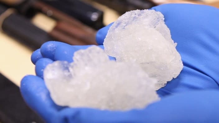 A detective holds crystal meth confiscated alongside firearms as part of a drug raid. According to new research, methamphetamine use is surging among African Americans. (Photo: Phil Walter/Getty Images)