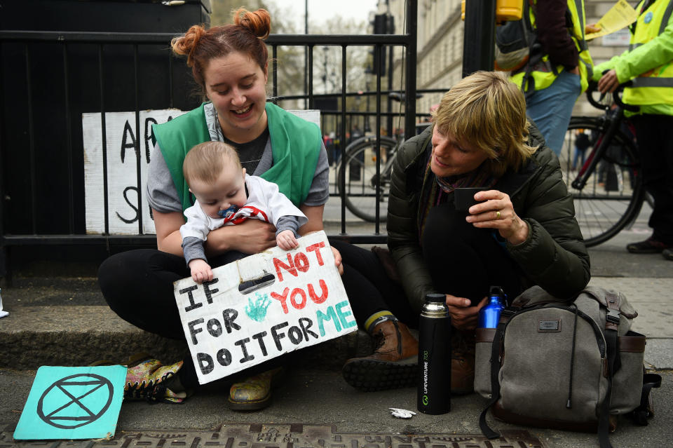 Demonstrators, including 6 month old Pheonix, during an Extinction Rebellion protest in Parliament Square, London, as more than 100 people have been arrested as police deal with ongoing climate change protests. PRESS ASSOCIATION Photo. Picture date: Tuesday April 16, 2019. See PA story ENVIRONMENT Climate. Photo credit should read: Kirsty O'Connor/PA Wire