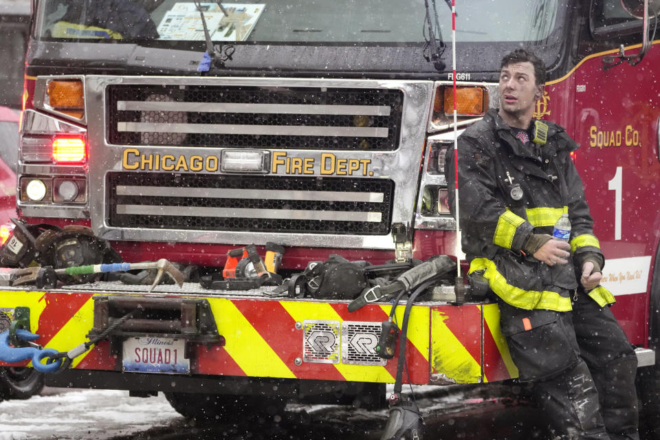 Chicago Firefighter Mose Demasi looks up at the Harper Square cooperative residential building after he and others fought a multi-floor fire at the high-rise in the Kenwood neighborhood of Chicago, Wednesday, Jan. 25, 2023. (AP Photo/Charles Rex Arbogast)