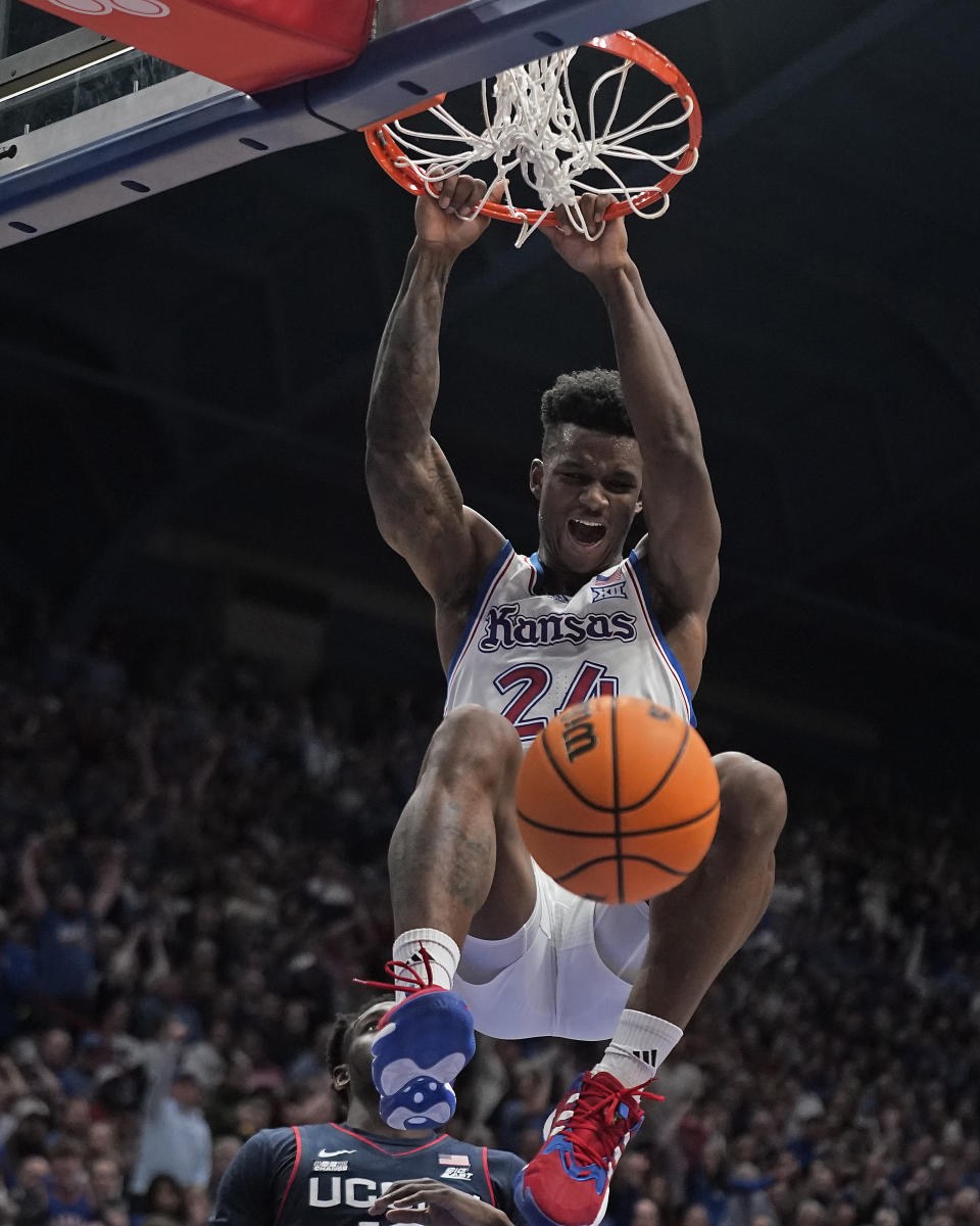 Kansas forward K.J. Adams Jr. dunks the ball during the first half of an NCAA college basketball game against UConn Friday, Dec. 1, 2023, in Lawrence, Kan. (AP Photo/Charlie Riedel)