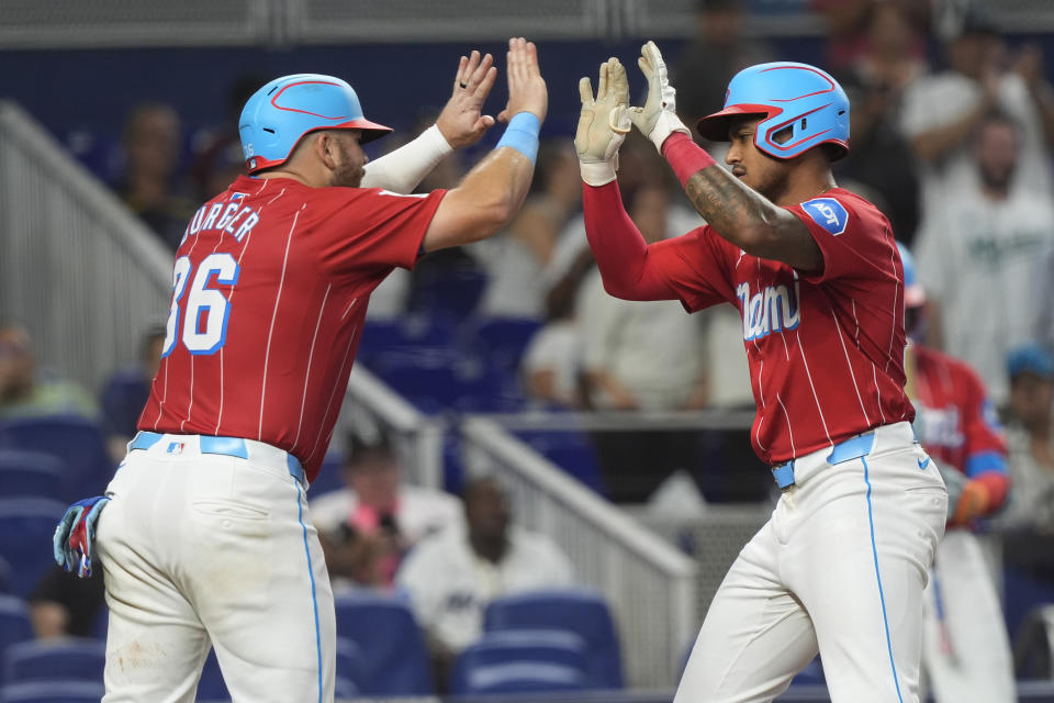 Miami Marlins' Dane Myers, right, celebrates after his two-run home run with Jake Burger (36) during the fourth inning of a baseball game against the Chicago White Sox, Saturday, July 6, 2024, in Miami. (AP Photo/Marta Lavandier)