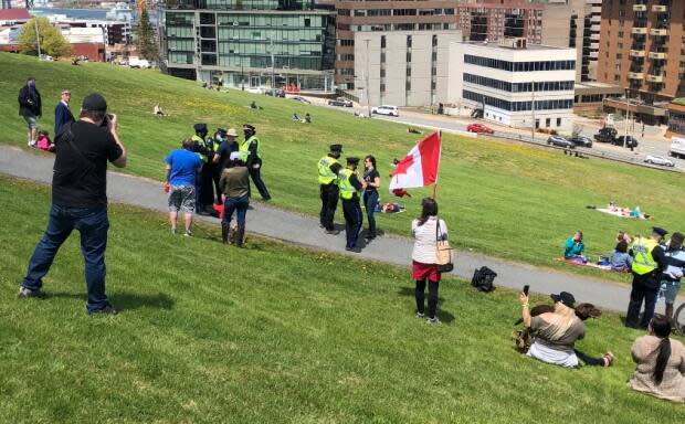 The group that planned the anti-mask rally in Halifax in May cancelled the event, but a handful of people not wearing masks gathered anyway. Police issued a number of tickets. (Vernon Ramesar/CBC - image credit)