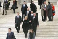 Members of the King v. Burwell plaintiffs' legal team, including attorney Sam Kazman (bottom L, red tie), Attorney General of Oklahoma Scott Pruitt (L, middle of stairs, in red tie), plaintiffs Pamela and Douglas Hurst (C, holding hands) and attorney Michael Carvin (3rd R, top stairs, in blue tie) exit the Supreme Court building after arguments in Washington, March 4, 2015. REUTERS/Jonathan Ernst