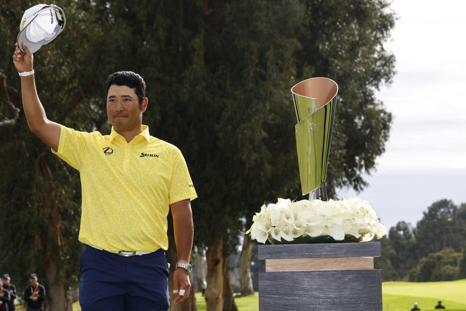 Hideki Matsuyama, of Japan, stands near the The Genesis Invitational trophy after he won the final round of the Genesis Invitational golf tournament at Riviera Country Club, Sunday, Feb. 18, 2024, in the Pacific Palisades area of, Los Angeles. (AP Photo/Ryan Kang)
