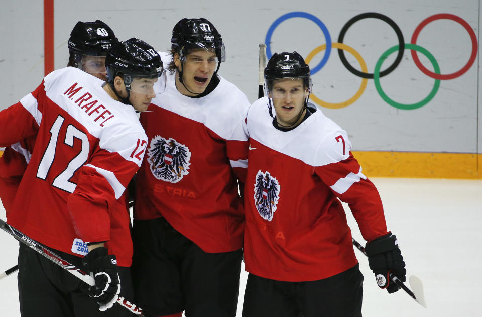 Austria celebrates a first period goal against Finland during a men's ice hockey game at the 2014 Winter Olympics, Thursday, Feb. 13, 2014, in Sochi, Russia. (AP Photo/Mark Humphrey)