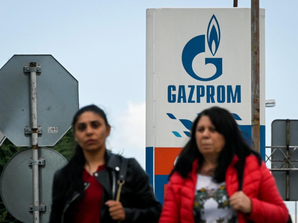 Two women walk past Russia's energy giant Gazprom at petrol stations in Sofia, Bulgaria, on April 27, 2022. Gazprom stopped all gas supplies to Poland and Bulgaria after not receiving payment in rubles.