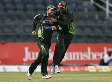 Pakistan's Ahmed Shehzad (L) celebrates with his teammate Imad Wasim after taking the catch to dismiss Sri Lanka's Lahiru Thirimanne (not pictured) during their fourth One Day International cricket match in Colombo July 22,2015. REUTERS/Dinuka Liyanawatte
