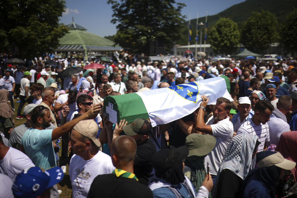 Bosnian muslim man carry the coffin with the remains of one of the 14 newly identified victims of the Srebrenica genocide, at the Srebrenica Memorial Centre, in Potocari, Bosnia, Thursday, July 11, 2024. Thousands gather in the eastern Bosnian town of Srebrenica to commemorate the 29th anniversary on Monday of Europe's only acknowledged genocide since World War II. (AP Photo/Armin Durgut)