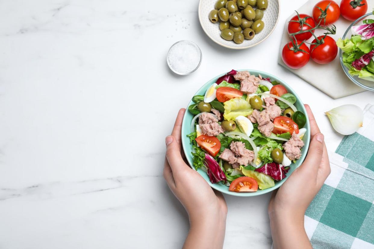   <span class="attribution"><a class="link " href="https://www.shutterstock.com/image-photo/woman-holding-bowl-delicious-salad-canned-2073591497" rel="nofollow noopener" target="_blank" data-ylk="slk:Shutterstock;elm:context_link;itc:0;sec:content-canvas">Shutterstock</a></span>