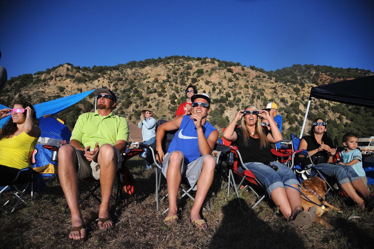 People react as they see a solar eclipse in Utah in 2012.