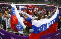 Russian fans cheer prior to the start of their men's preliminary round ice hockey game against Slovenia at the Sochi 2014 Winter Olympic Games February 13, 2014. REUTERS/Mark Blinch (RUSSIA - Tags: OLYMPICS SPORT ICE HOCKEY)