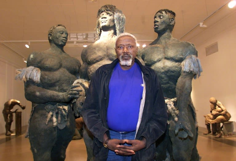 Senegalese sculptor Ousmane Sow posing in front of one of his artworks in Lyon in 1999